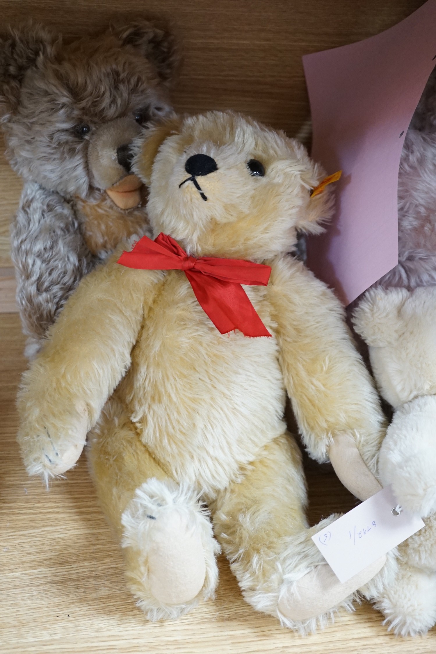 A large Steiff growler blonde plush teddy bear, 68cms long and four other Steiff teddy bears